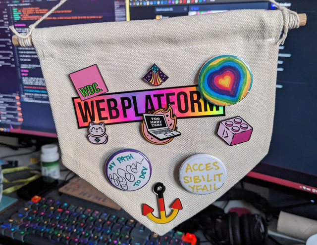 A small banner with a bunch of web development related and other badges, pinning a rainbow-holographic sticker saying 'WEB PLATFORM' in the middle.